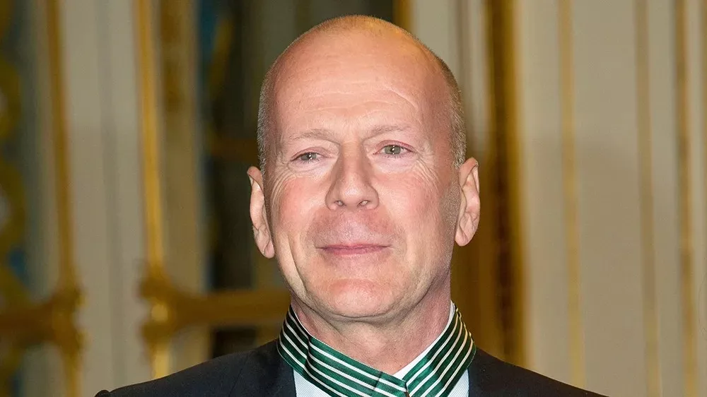 Image of Bruce Willis in black dress